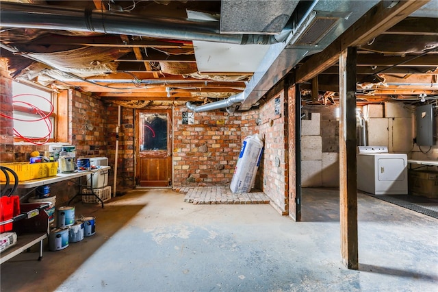 basement with electric panel and washer / clothes dryer