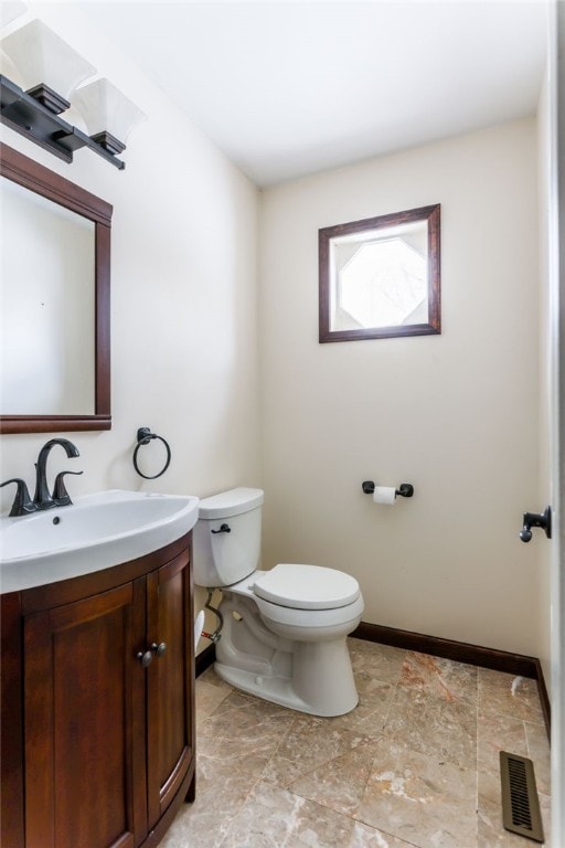 bathroom featuring toilet and vanity