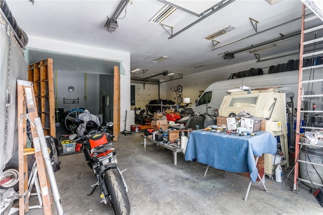 garage with a garage door opener and electric panel