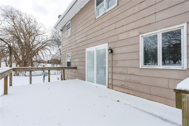 view of snow covered exterior with a deck