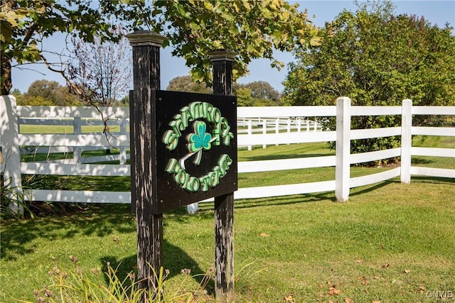 view of gate featuring a yard