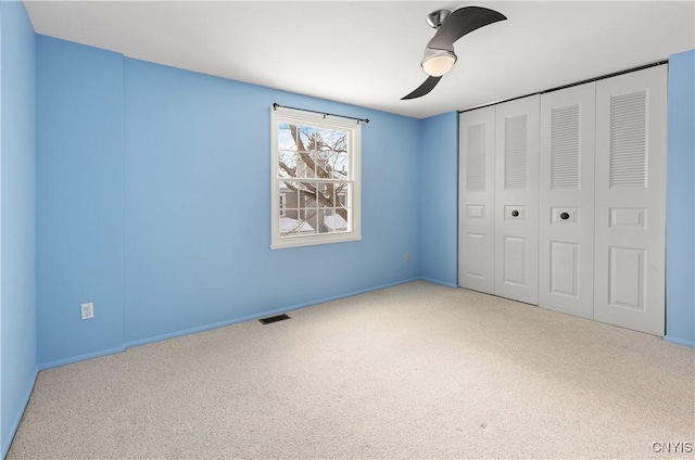 unfurnished bedroom featuring ceiling fan, carpet flooring, and a closet