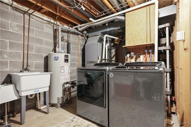 washroom featuring sink, washer and dryer, and gas water heater