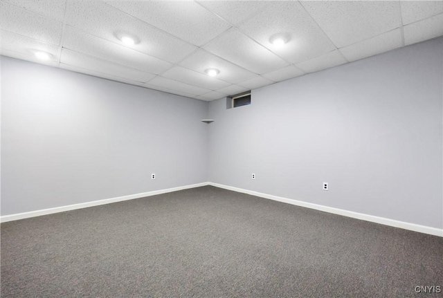 carpeted empty room with a drop ceiling