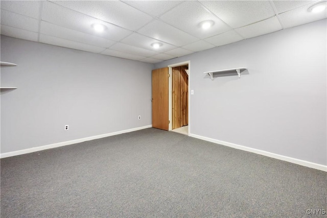 carpeted spare room with a drop ceiling