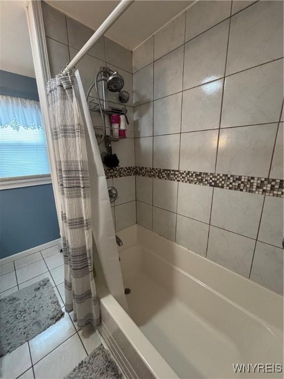 bathroom with tile patterned flooring and shower / tub combo