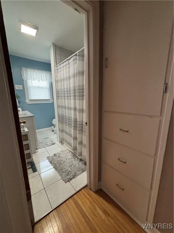 bathroom with hardwood / wood-style flooring, vanity, and toilet