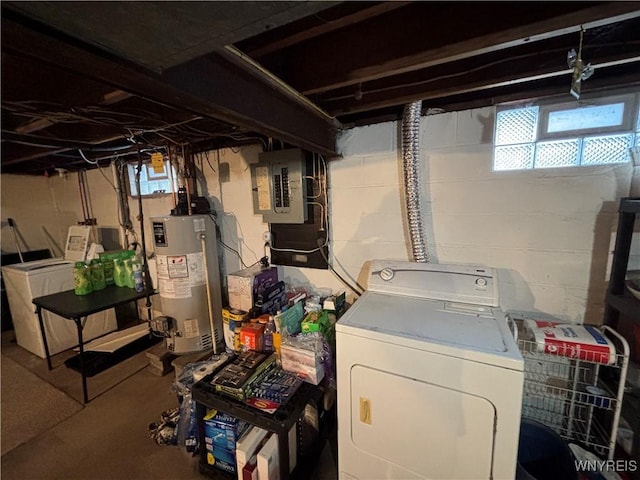 basement featuring electric panel, washer and dryer, and gas water heater