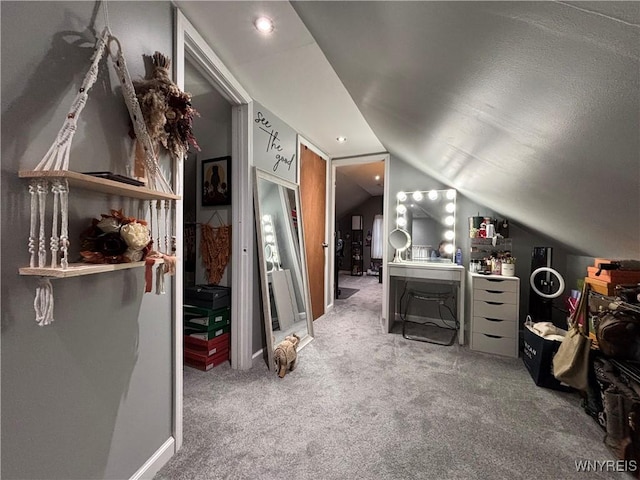 bonus room with vaulted ceiling and carpet flooring