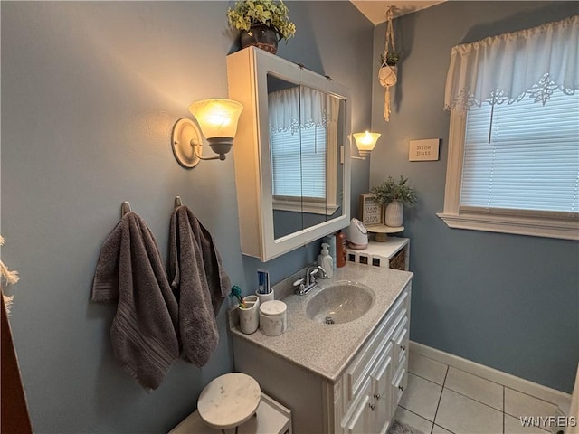 bathroom with a healthy amount of sunlight, tile patterned flooring, and vanity