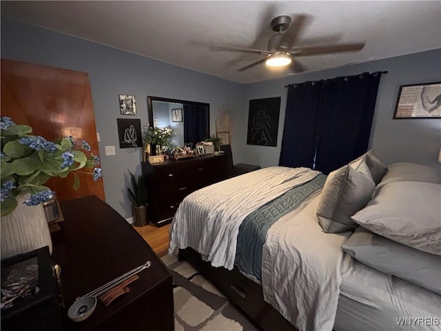 bedroom featuring hardwood / wood-style floors and ceiling fan