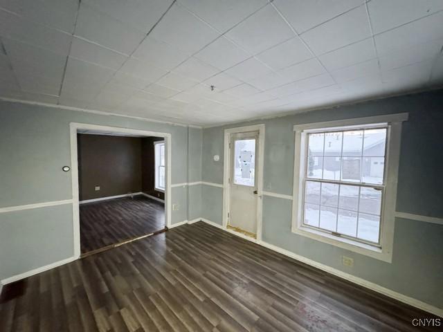 unfurnished room with dark hardwood / wood-style flooring