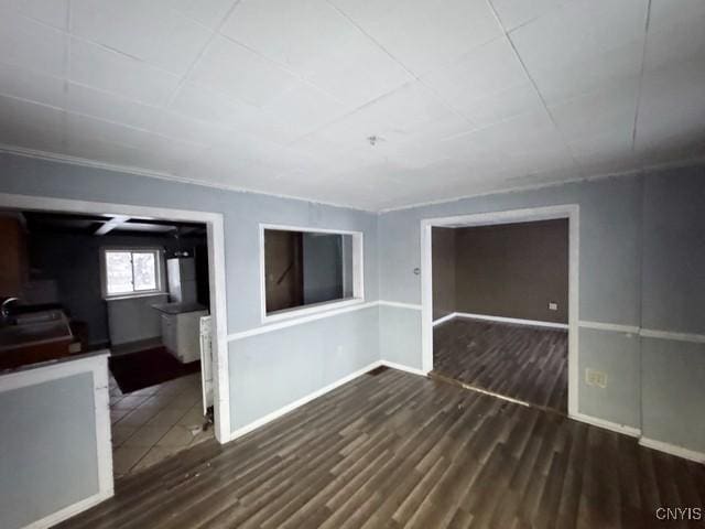 unfurnished room featuring dark wood-type flooring and sink