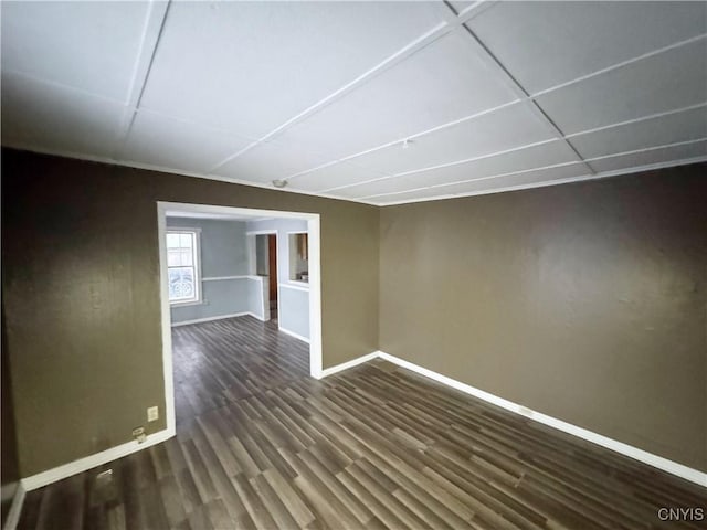 empty room with dark wood-type flooring