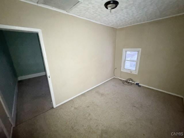 carpeted empty room featuring a textured ceiling