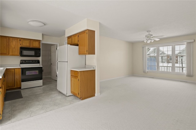 kitchen featuring ceiling fan, white appliances, and light carpet