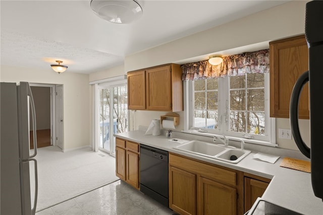 kitchen featuring sink, a textured ceiling, and black appliances