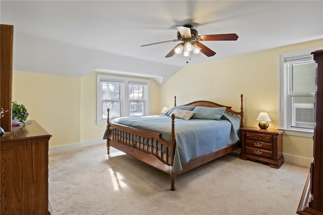 bedroom featuring lofted ceiling, ceiling fan, and light colored carpet