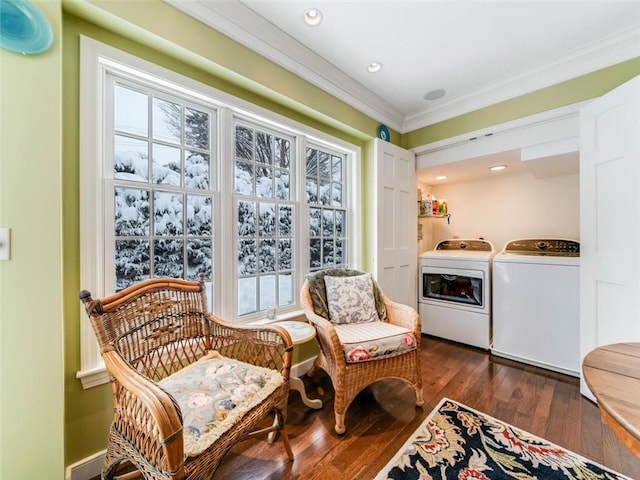 sitting room featuring dark hardwood / wood-style floors, ornamental molding, and washing machine and clothes dryer