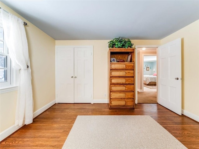 unfurnished bedroom featuring hardwood / wood-style floors and a closet