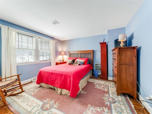 bedroom with hardwood / wood-style floors