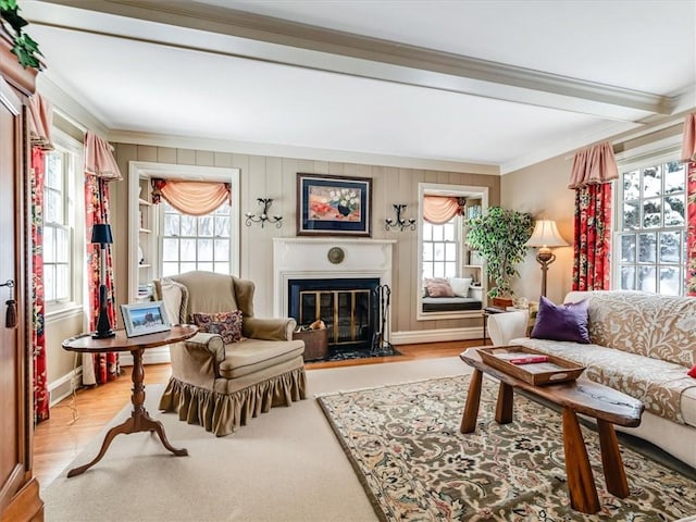 living room with light wood-type flooring, crown molding, and beam ceiling