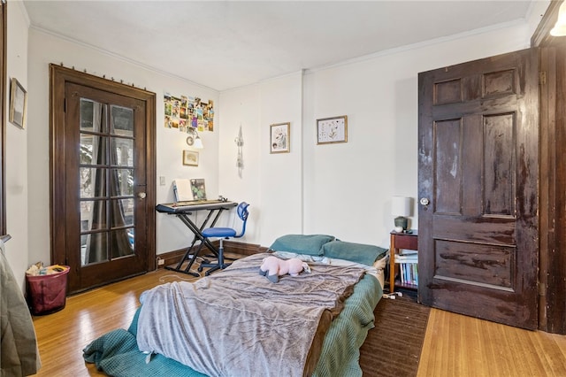 bedroom featuring crown molding and light wood-type flooring