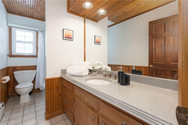 bathroom featuring wooden walls, wood ceiling, tile patterned floors, and vanity