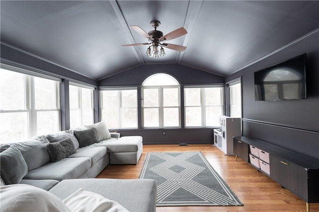 living room featuring ceiling fan, lofted ceiling, and light hardwood / wood-style flooring