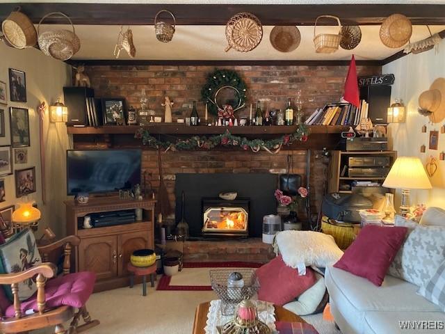 carpeted living room with a wood stove