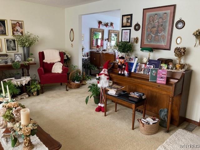 living area featuring light carpet