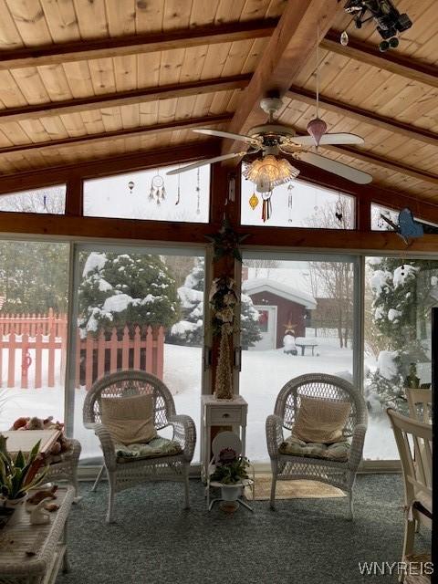 sunroom featuring ceiling fan, wood ceiling, and vaulted ceiling