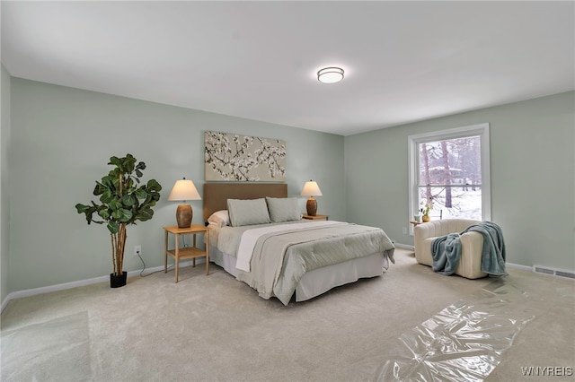 bedroom featuring light colored carpet, visible vents, and baseboards