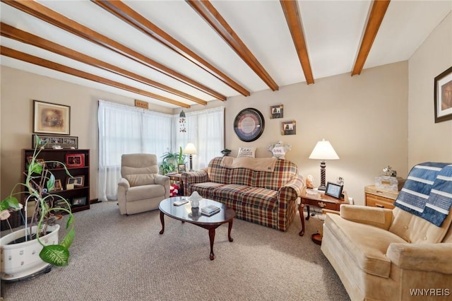 carpeted living room with beam ceiling