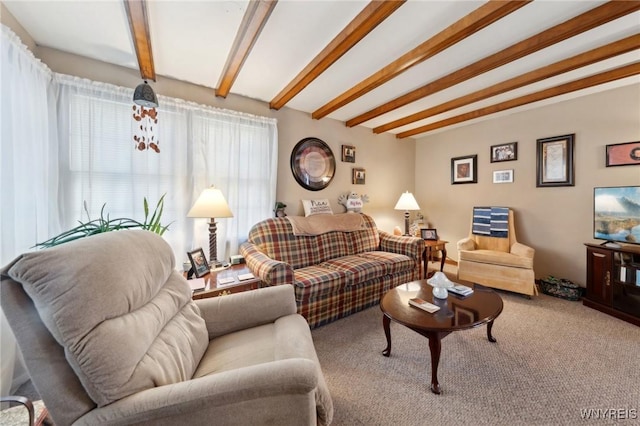 living area featuring carpet floors and beamed ceiling