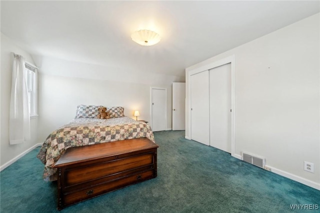 bedroom featuring baseboards, visible vents, dark carpet, and a closet