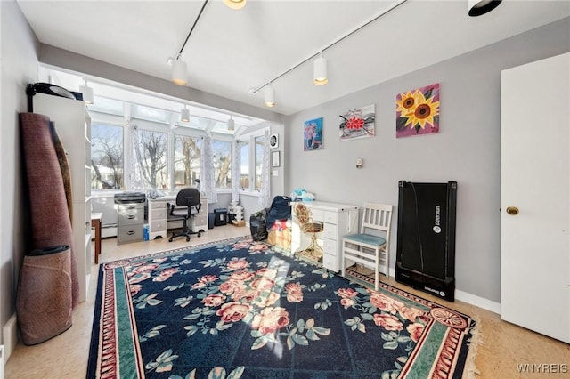 interior space featuring track lighting and baseboards