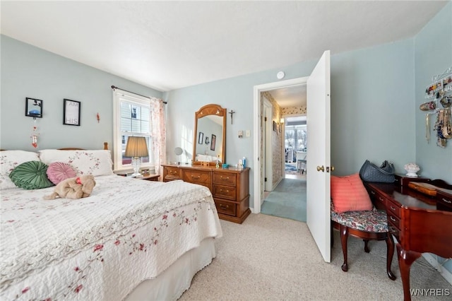 bedroom featuring light carpet