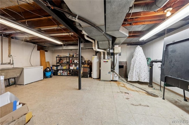 unfinished below grade area with fridge, gas water heater, tile patterned floors, and heating unit