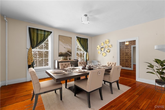 dining room with baseboards and wood finished floors