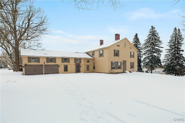 view of snow covered back of property