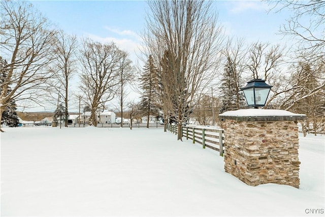 yard layered in snow with fence