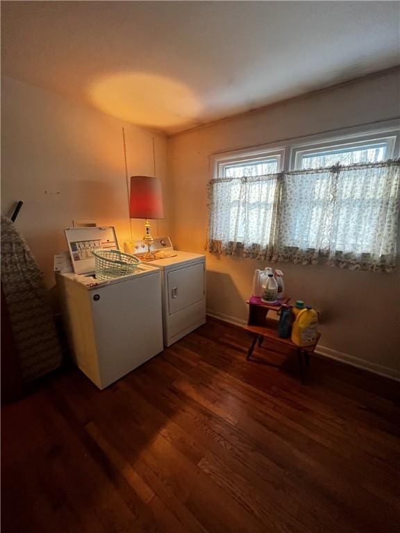 kitchen featuring dark wood-style floors, washing machine and dryer, and light countertops