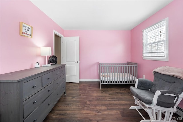 bedroom featuring dark wood-style floors and baseboards