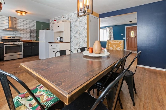 dining space featuring baseboards and wood finished floors