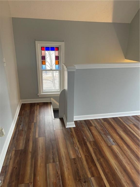 interior space with baseboards and dark wood finished floors