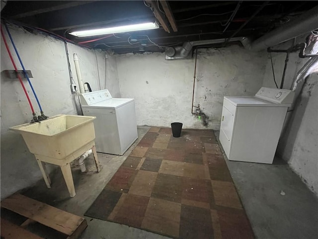 laundry room with laundry area, washer and clothes dryer, and a sink