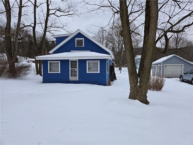 view of front of property featuring a garage and an outdoor structure