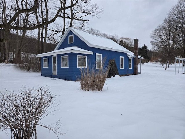 view of front of house featuring a chimney