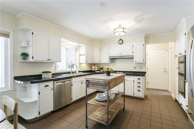 kitchen with open shelves, stainless steel dishwasher, white cabinetry, a sink, and under cabinet range hood